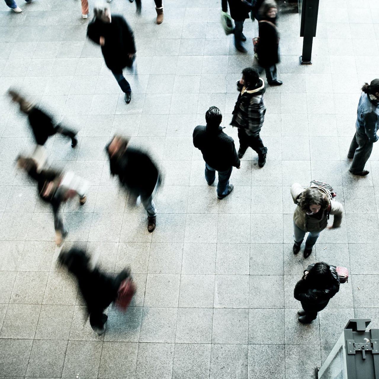 people walking on grey concrete floor during daytime